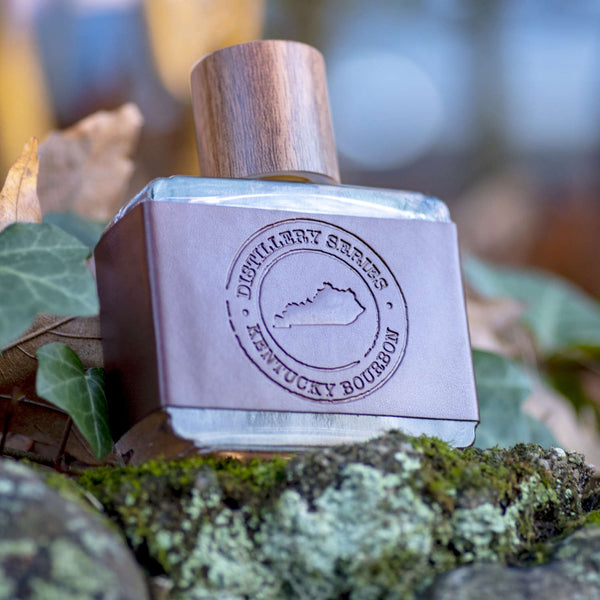 Kentucky Cologne bottle lying on plants