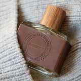 Tennessee Whiskey Cologne bottle over a wool sweater