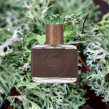 Alabama oakmoss scent vegan leather green background whiskey cologne