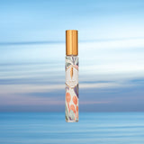 ethereal travel size bottle gold cap sky background blue flowers